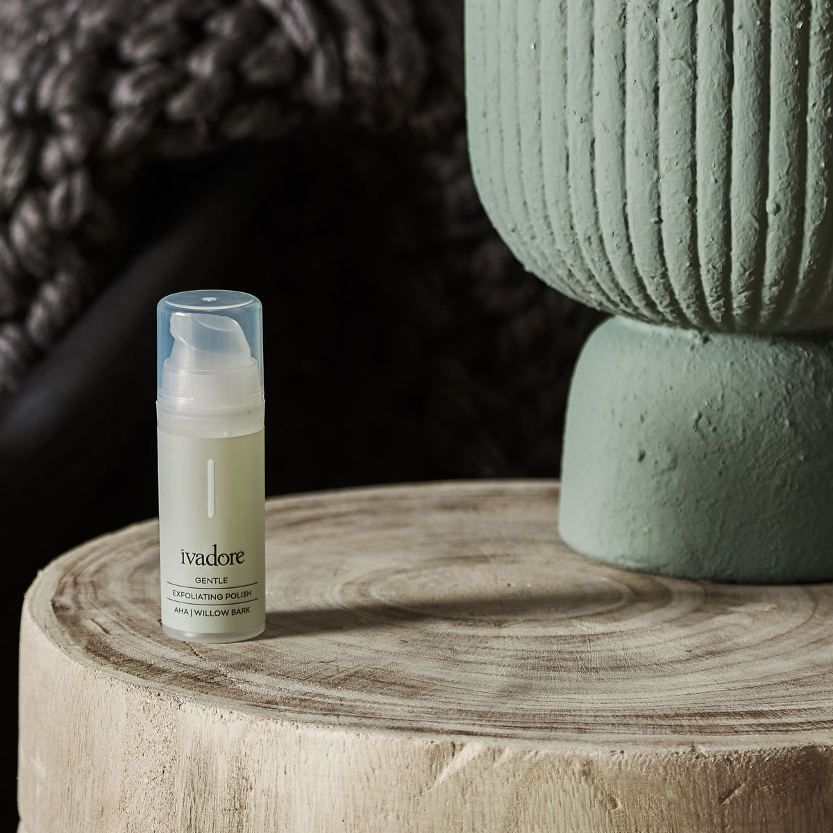 Gentle Exfoliating Polish in packaging on wooden table with styled ceramic vase