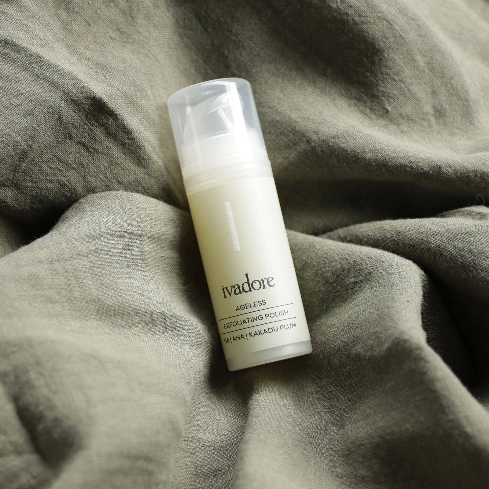 Ivadore Ageless Exfoliating Polish 30mL bottle on khaki linen background