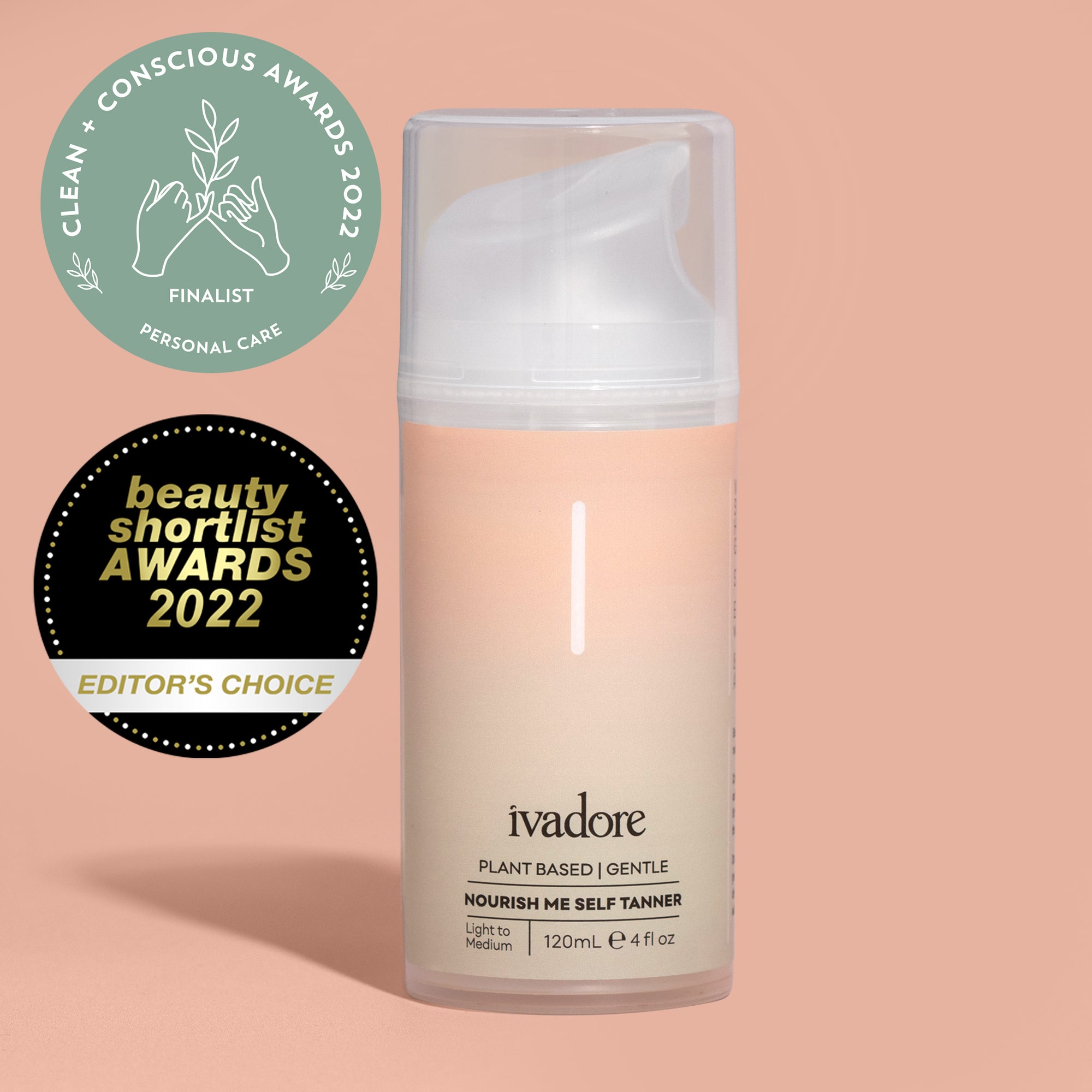 Nourish Me Self Tanner bottle standing on peach coloured background with shadow and award badges