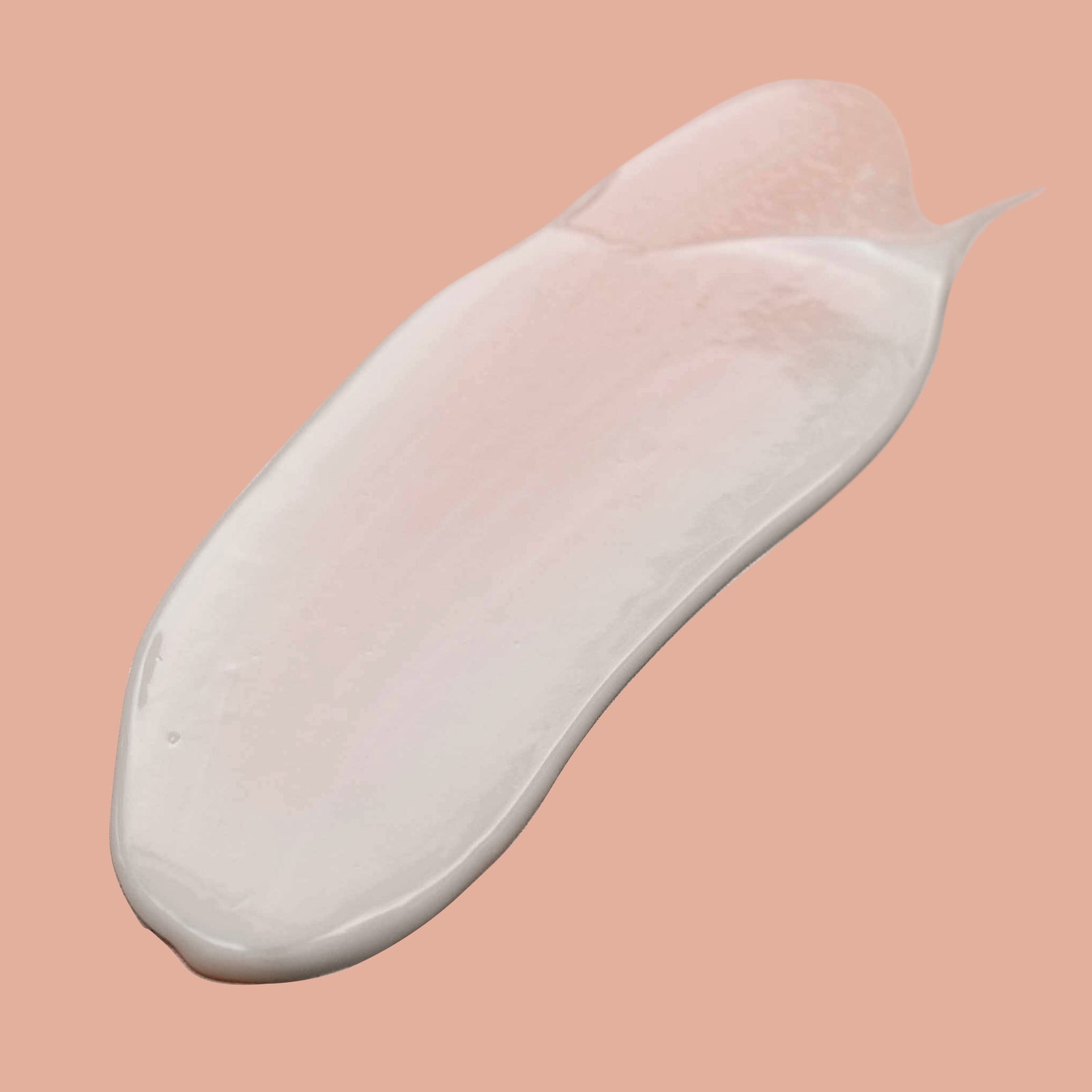 Nourish Me Self Tanner bottle standing on peach coloured background with shadow and award badges