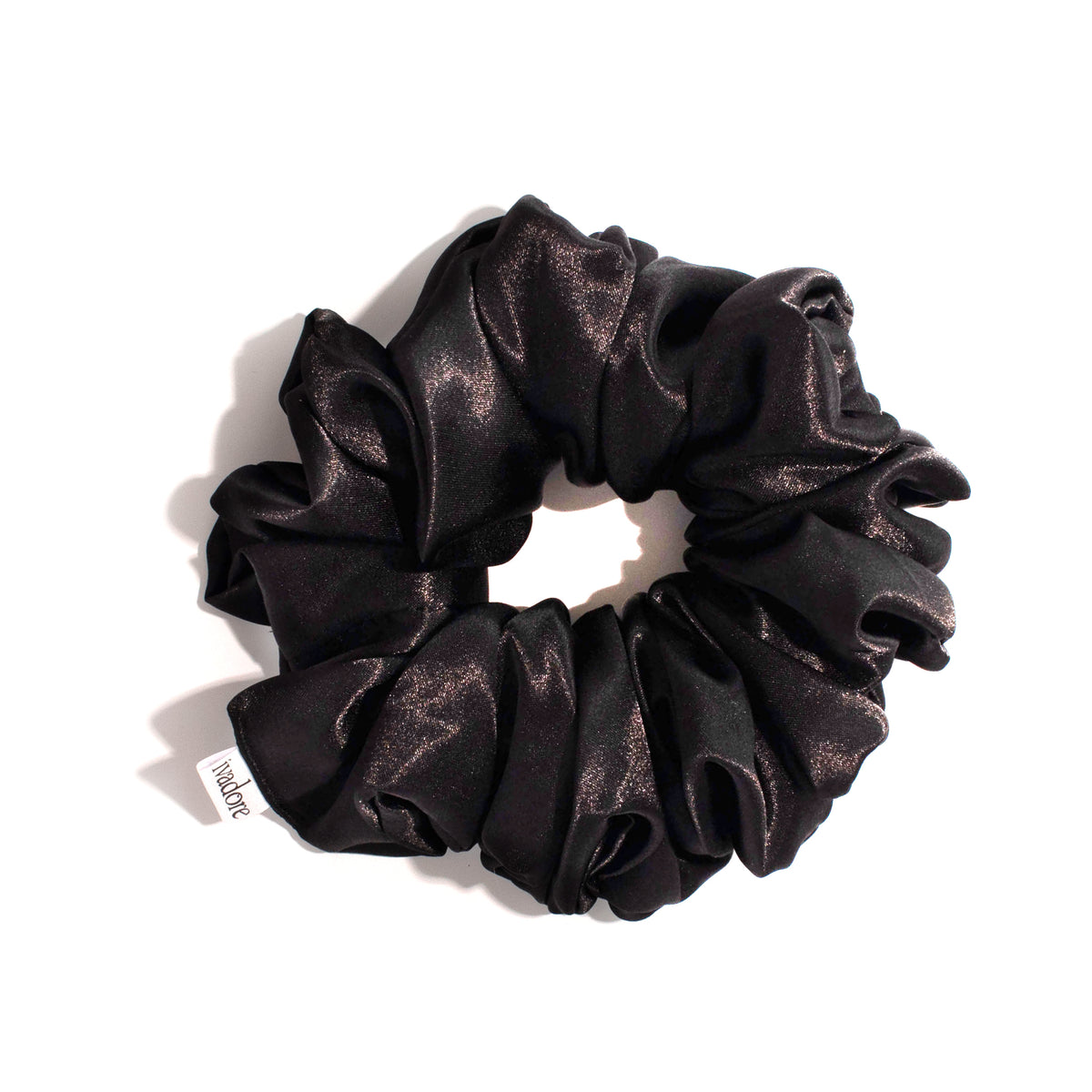 Black silky scrunchie on white background with shadow