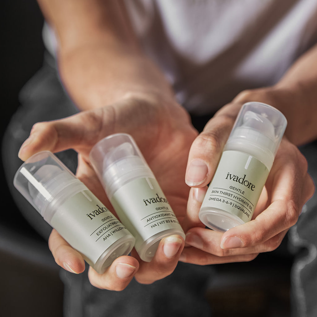 Female hands holding three mini bottles from the Gentle Skin System set 