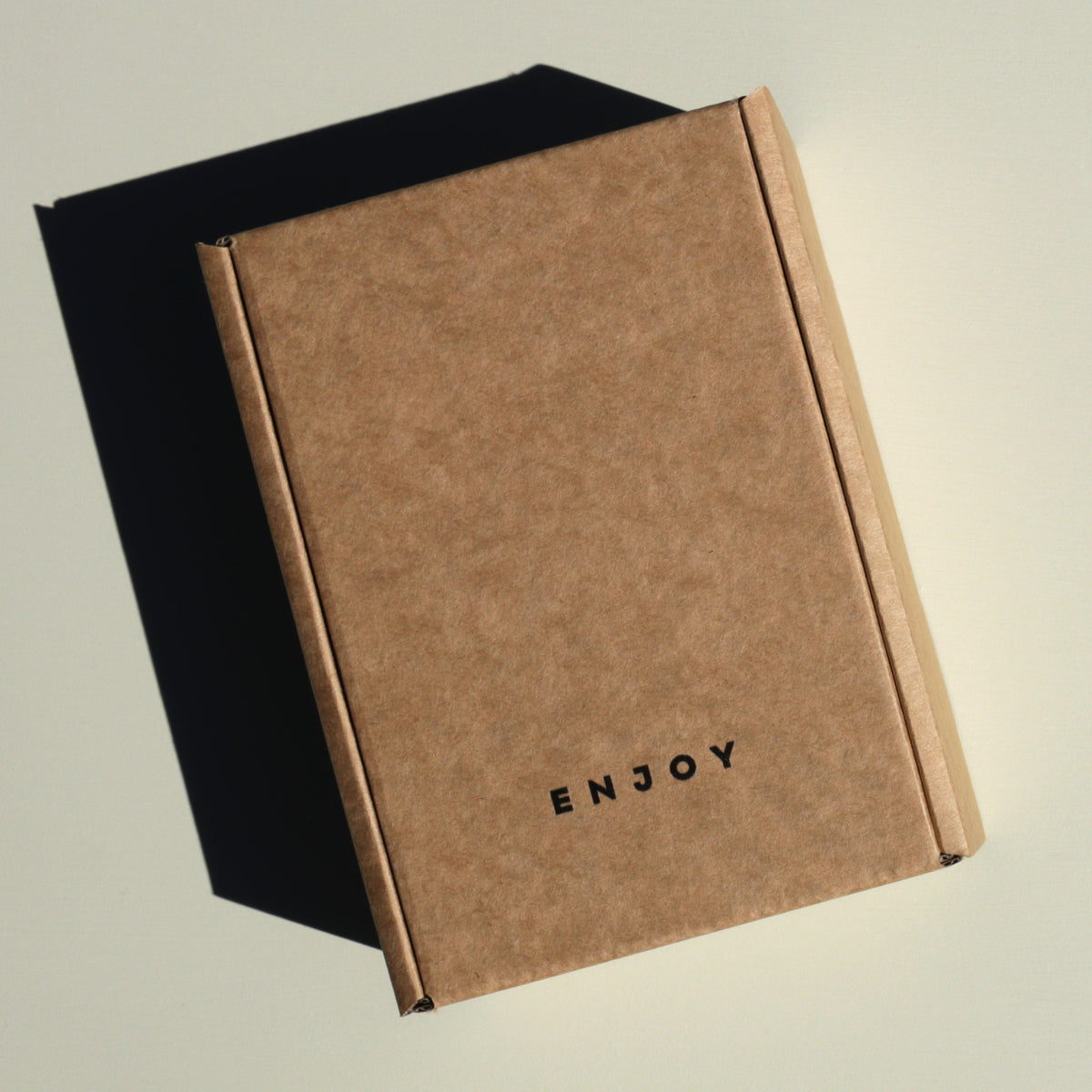 Recycled kraft paper box with text saying enjoy